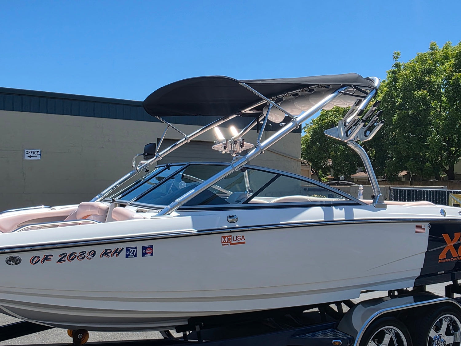 X2 masterraft in white with black bimini top and white speakers
